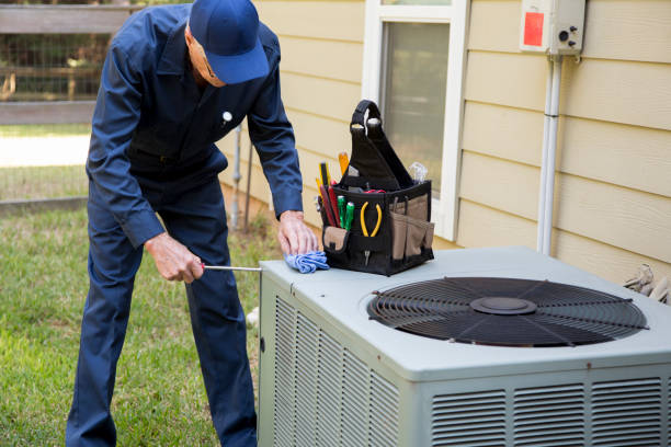 senior adult air conditioner technician/electrician services outdoor unit.